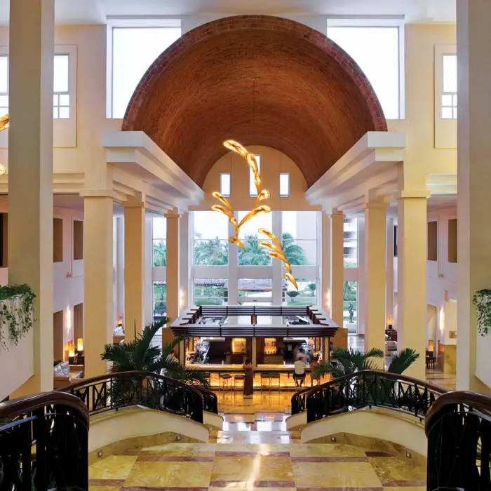 Stylish lobby bar with dramatic lighting and elegant architecture at Excellence Playa Mujeres in Cancun.
