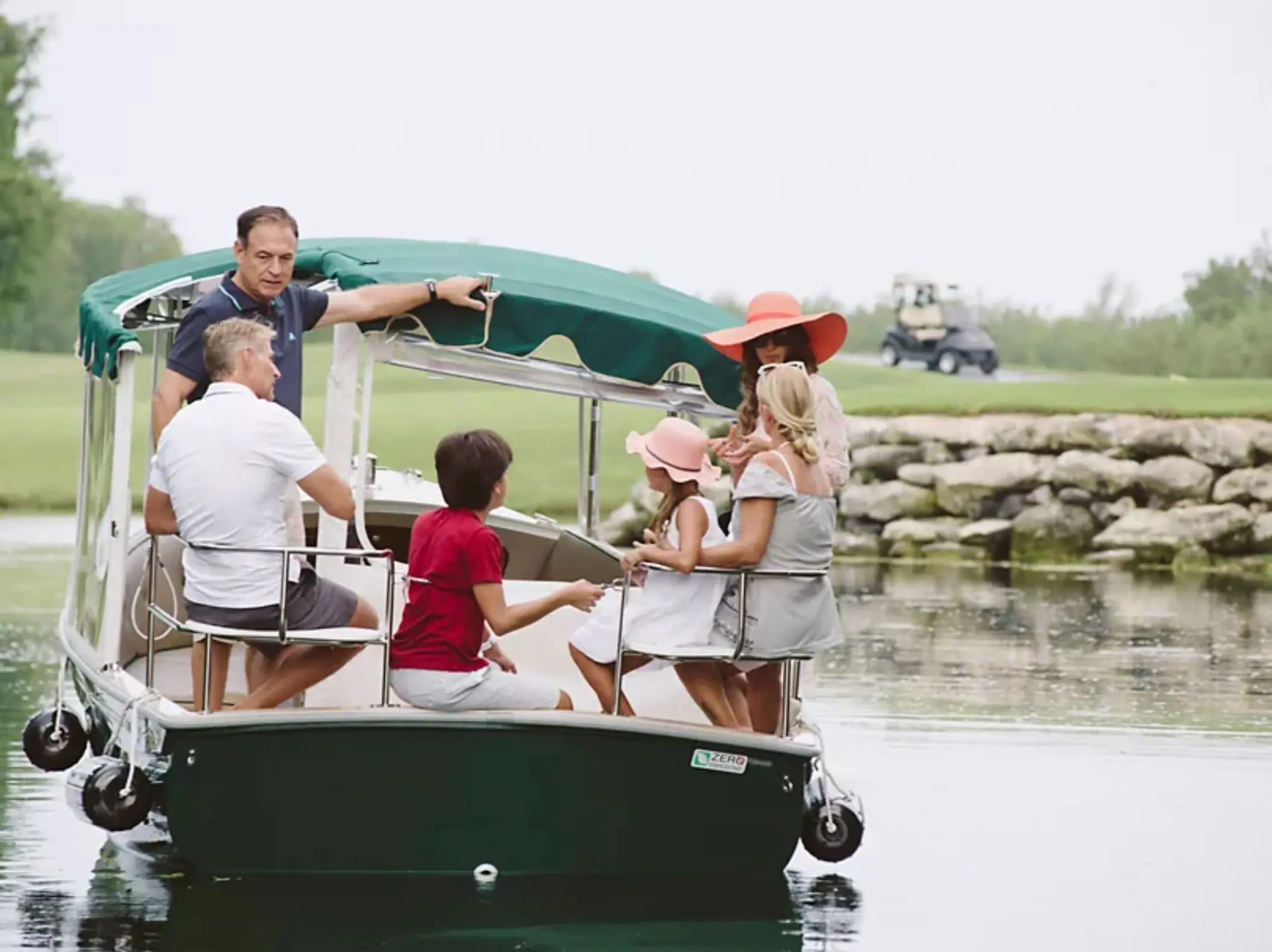 family on the boat the at golf course at Fairmont Heritage Place Mayakoba