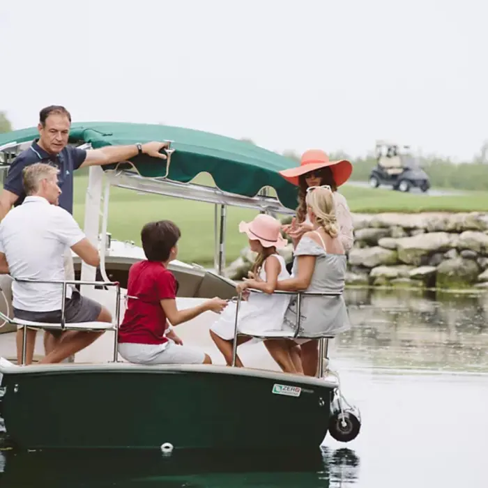 family on the boat the at golf course at Fairmont Heritage Place Mayakoba