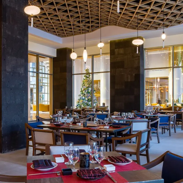 Modern dining space with warm lighting, decorative wall panels, and contemporary Japanese design.