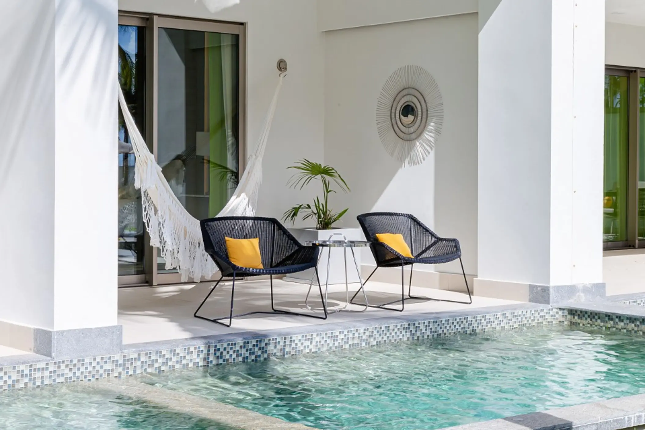Modern Junior Suite with direct swim-up access, king bed, and neutral decor opening to the pool area.
