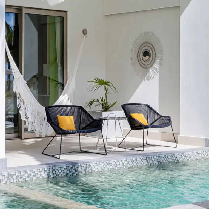 Modern Junior Suite with direct swim-up access, king bed, and neutral decor opening to the pool area.