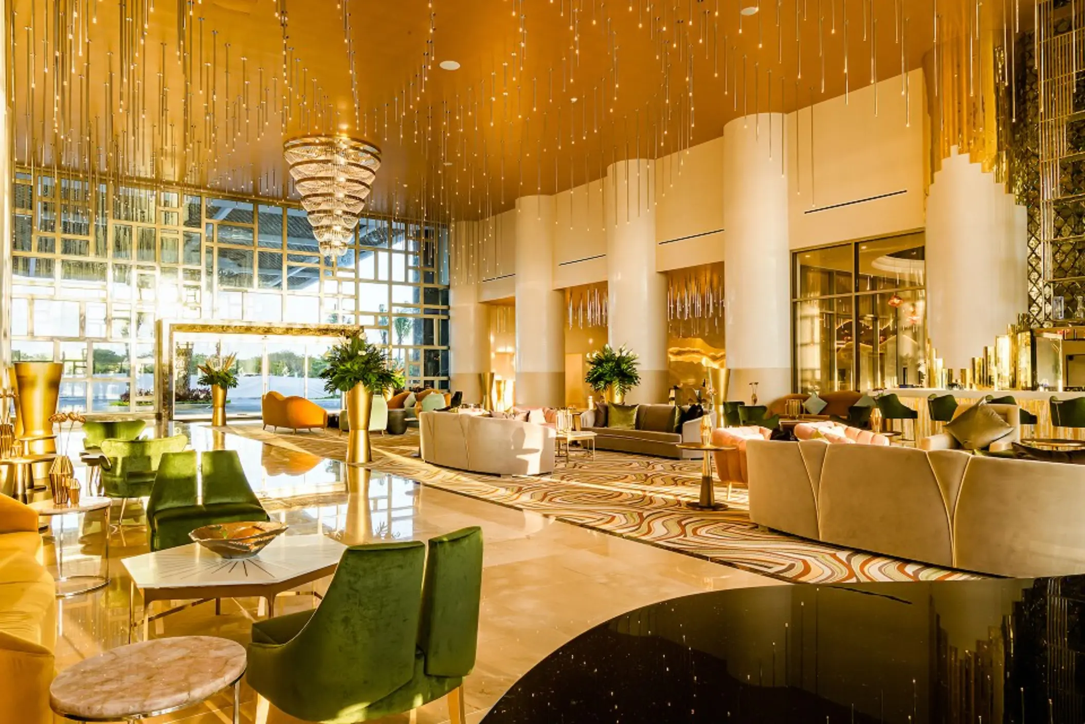 Spacious resort lobby with curved wooden ceiling design, plush seating, and warm ambient lighting.