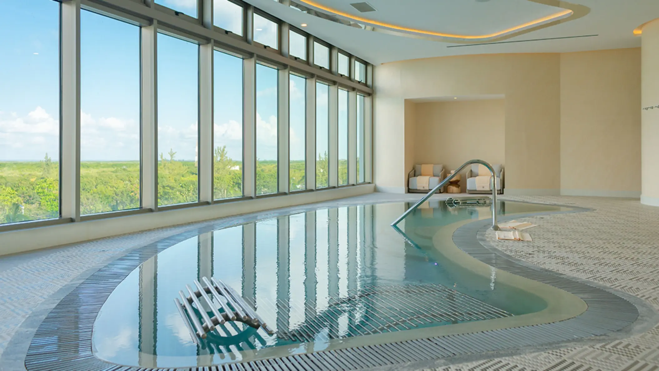 Spacious spa cabin with soft lighting, massage beds, and wall art creating a serene and calming atmosphere.