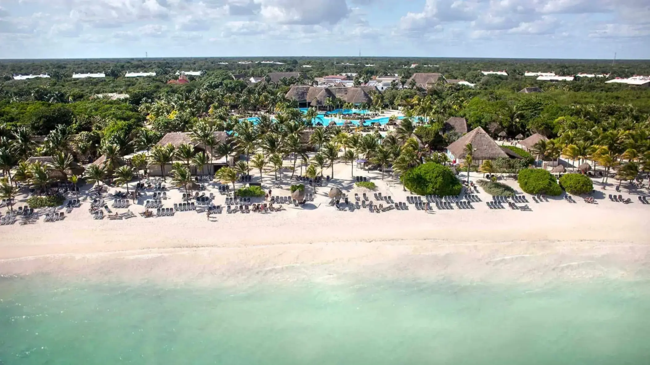 aerial view of Grand Palladium Colonial with its pools and buildings and beach
