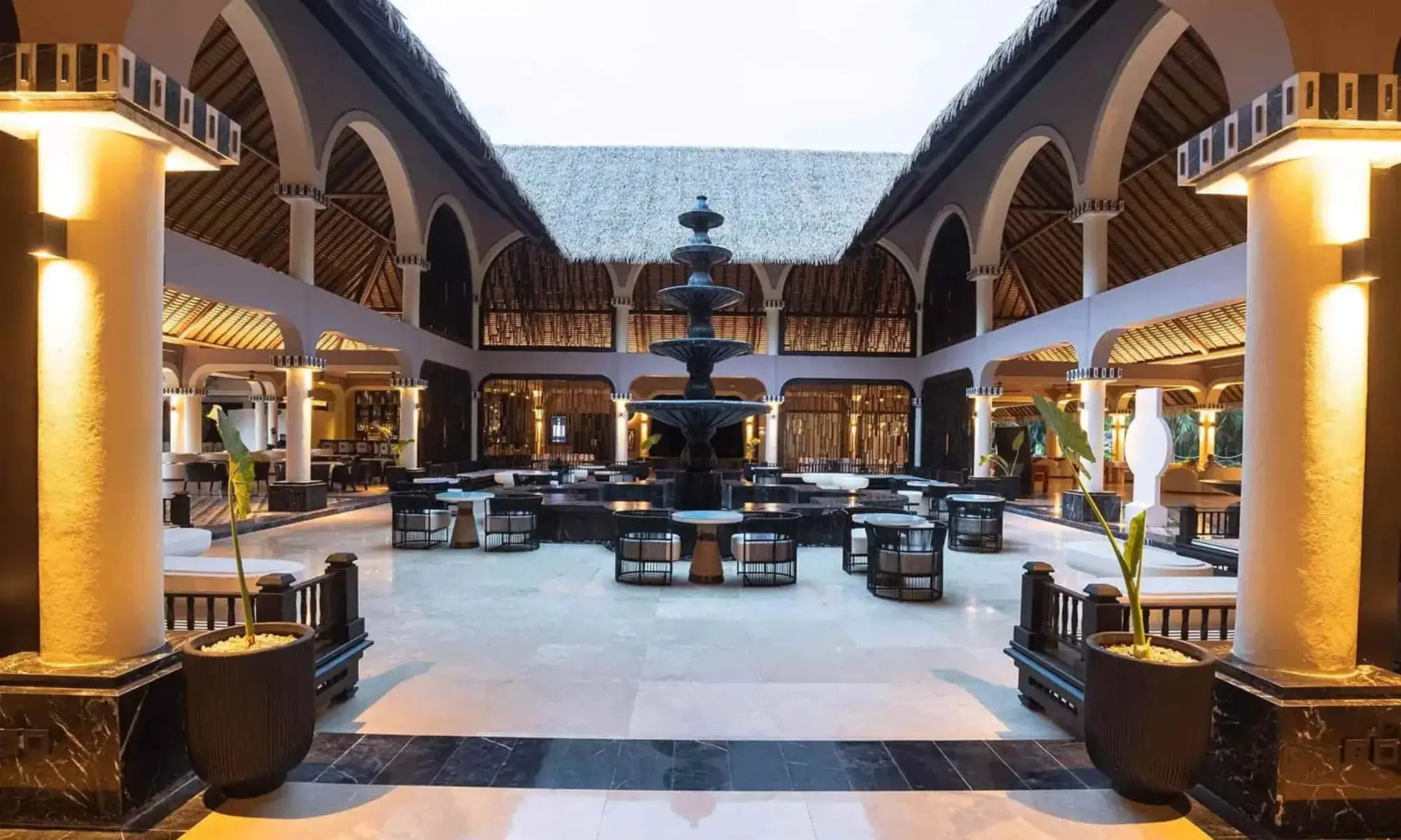 central fountain with seating around it at grand palladium colonial