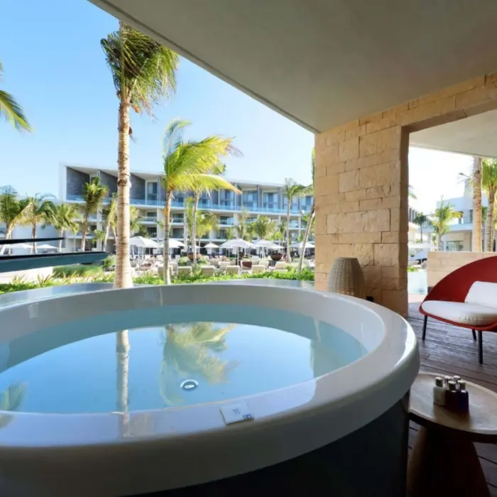 Spacious terrace suite with outdoor soaking tub and garden view.