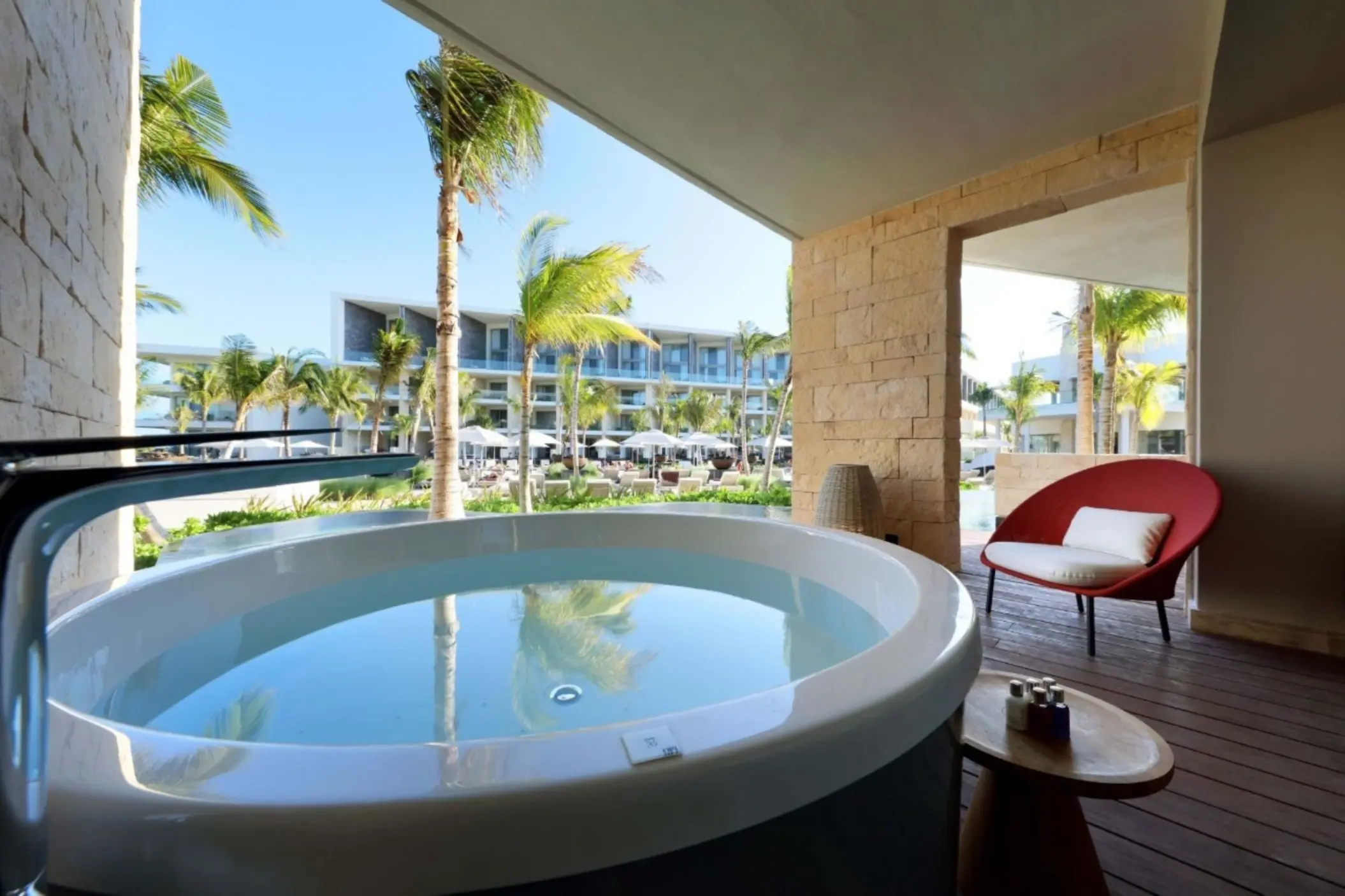 Spacious terrace suite with outdoor soaking tub and garden view.
