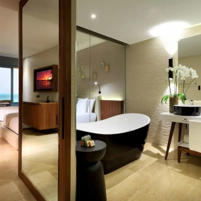 Modern oceanview suite with standalone tub and dual sinks.