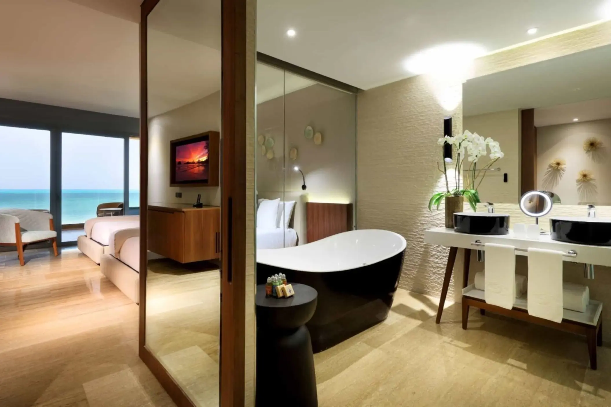 Modern oceanview suite with standalone tub and dual sinks.