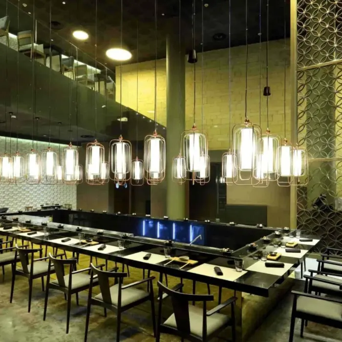 Elegant sushi restaurant with sleek decor, modern lighting, and spacious bar seating for interactive dining.