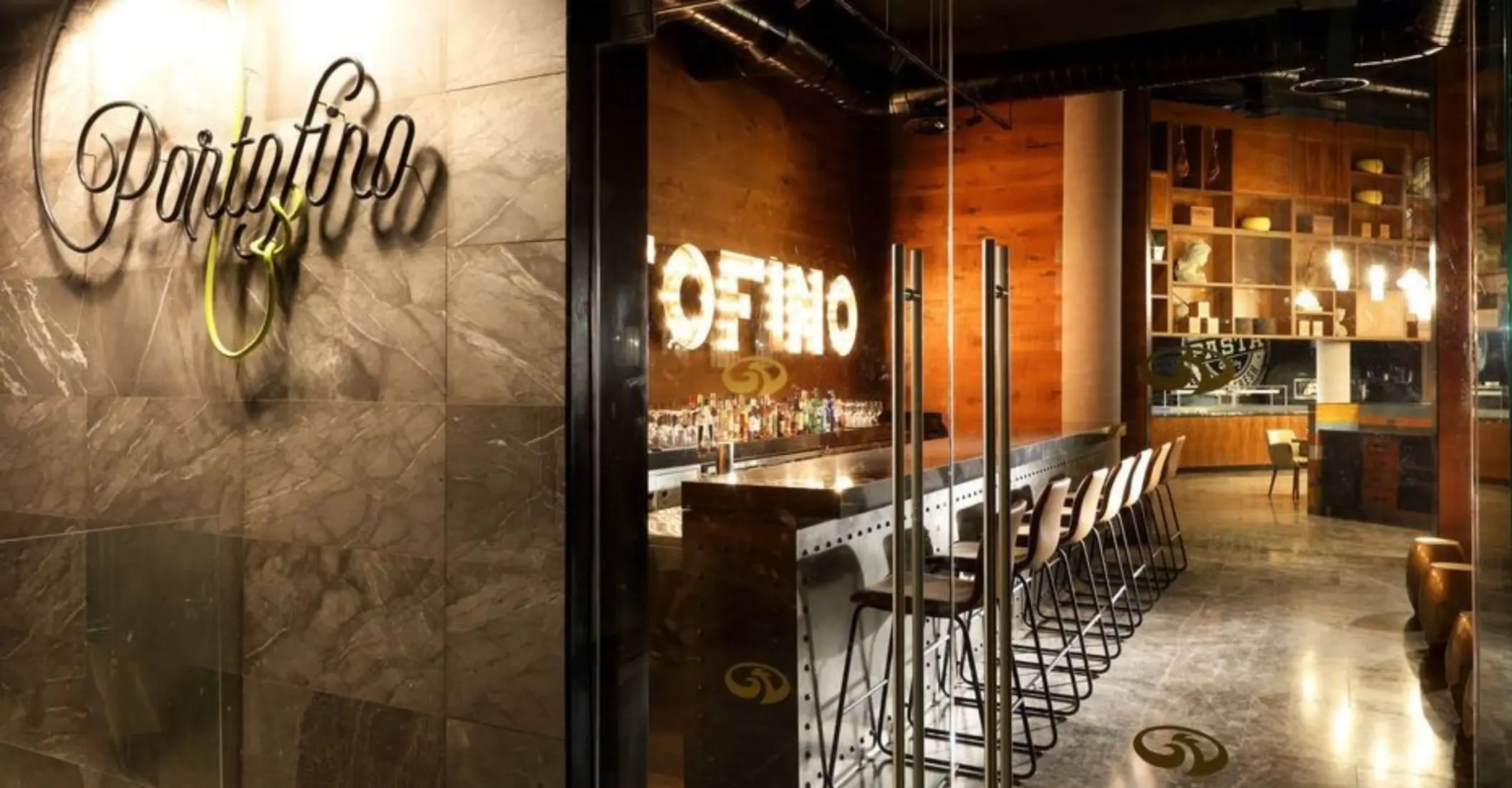 Entrance to Portofino Italian restaurant with stylish signage and sleek bar interior.