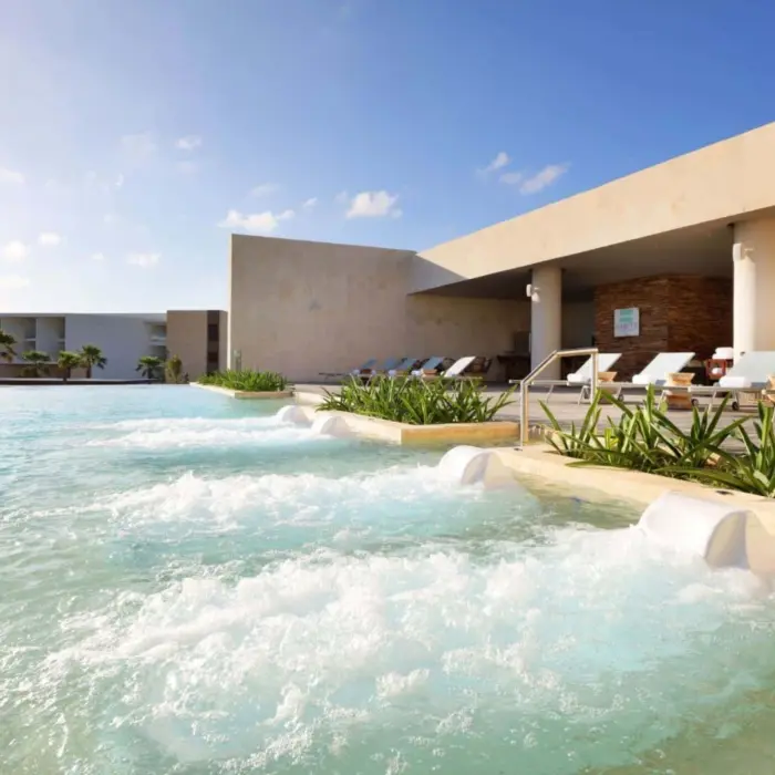 Heated outdoor spa pool area with hydrotherapy jets and modern resort surroundings.