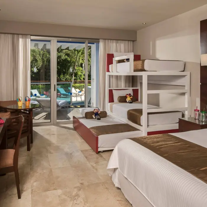 Family Club Deluxe Swimout Jacuzzi room with bunk beds, a king bed, and direct access to a pool.