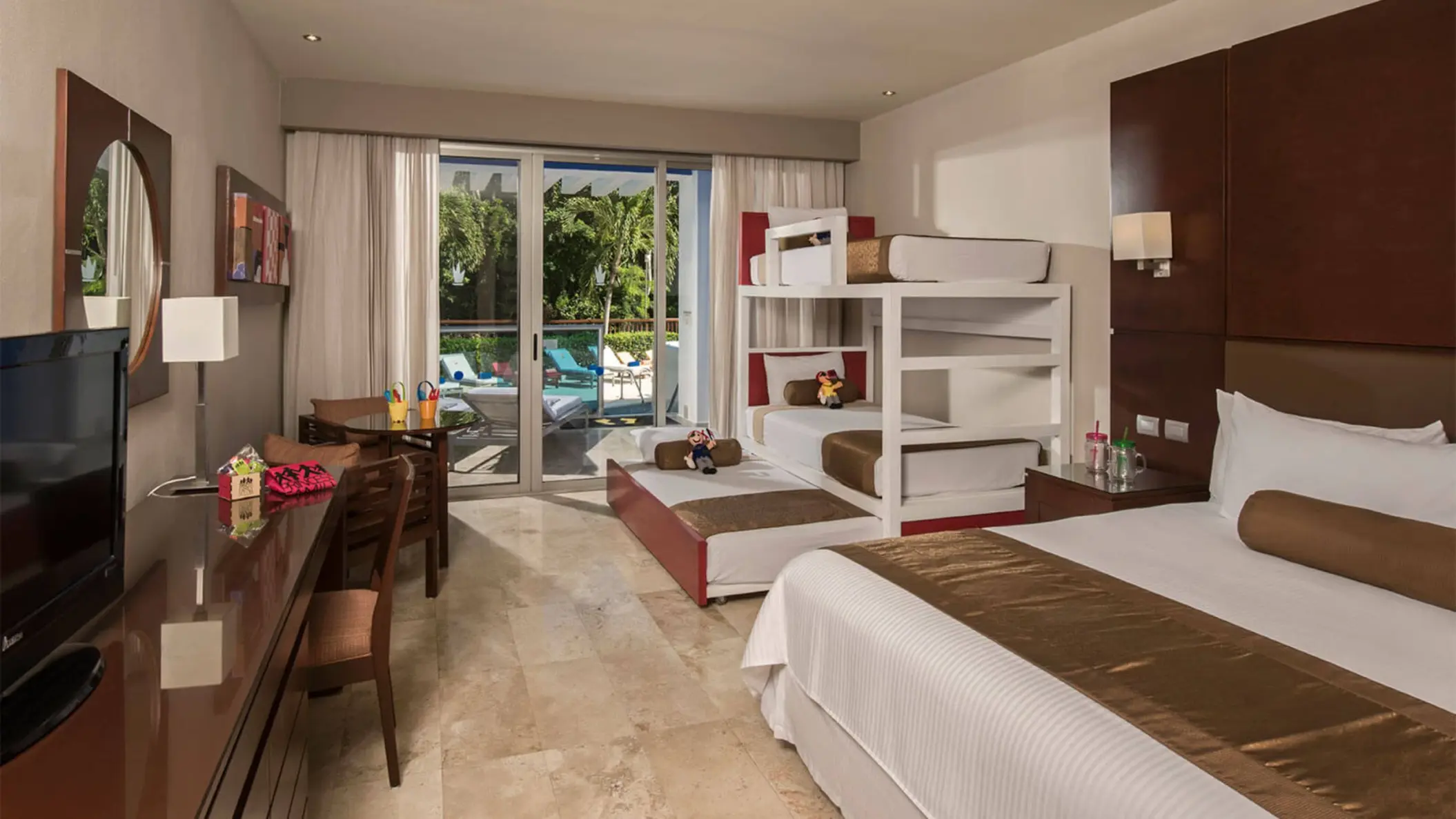 Family Club Deluxe Swimout Jacuzzi room with bunk beds, a king bed, and direct access to a pool.