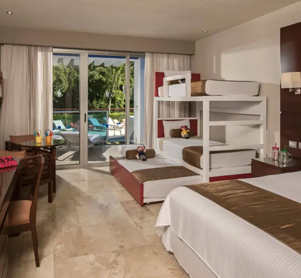 Family Club Deluxe Swimout Jacuzzi room with bunk beds, a king bed, and direct access to a pool.