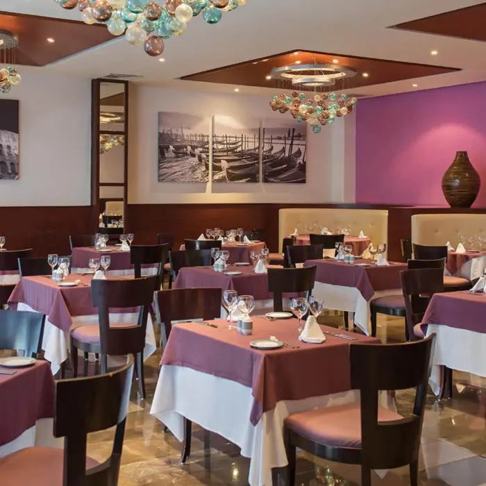 Mamma Mia restaurant at Grand Riviera Princess with tables set for dining and charming Italian-themed decor.