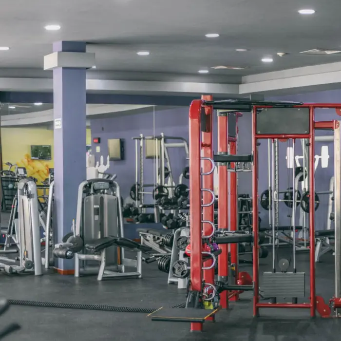 Well-equipped gym at Grand Riviera Princess with various modern exercise machines and mirrored walls.