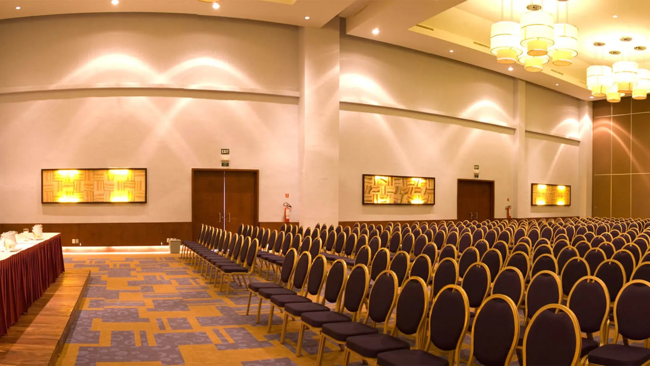 Large, organized meeting and conference room at Grand Riviera Princess with rows of chairs facing a presentation table.