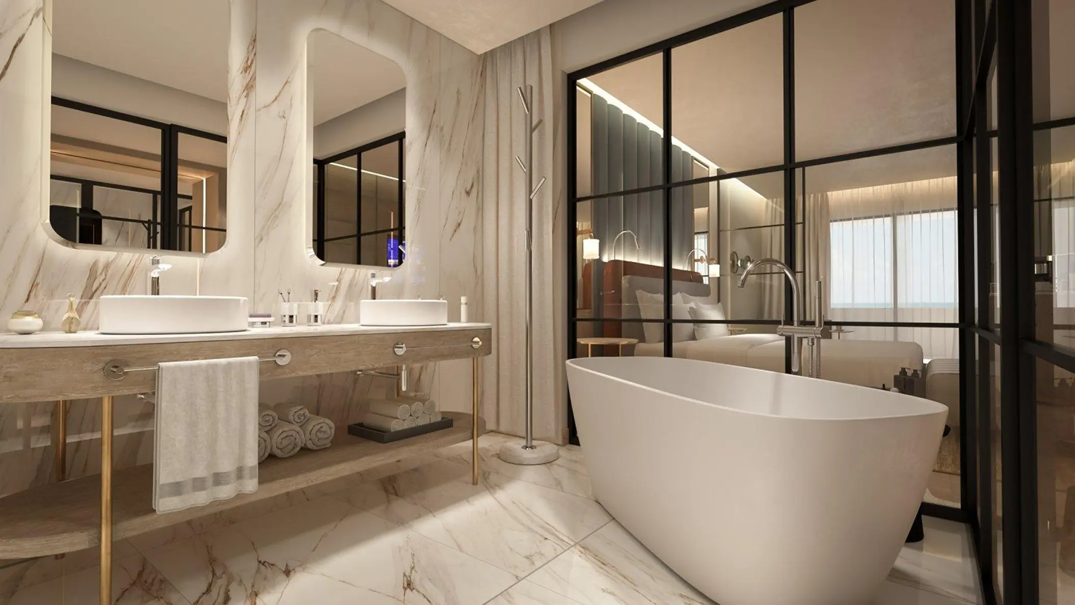 Modern bathroom at Grand Sunset Princess with marble walls, double vanity, free-standing tub, and glass wall to bedroom.