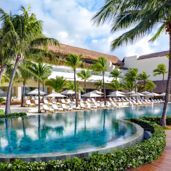 pool with poolside loungers at grand velas riviera maya resort