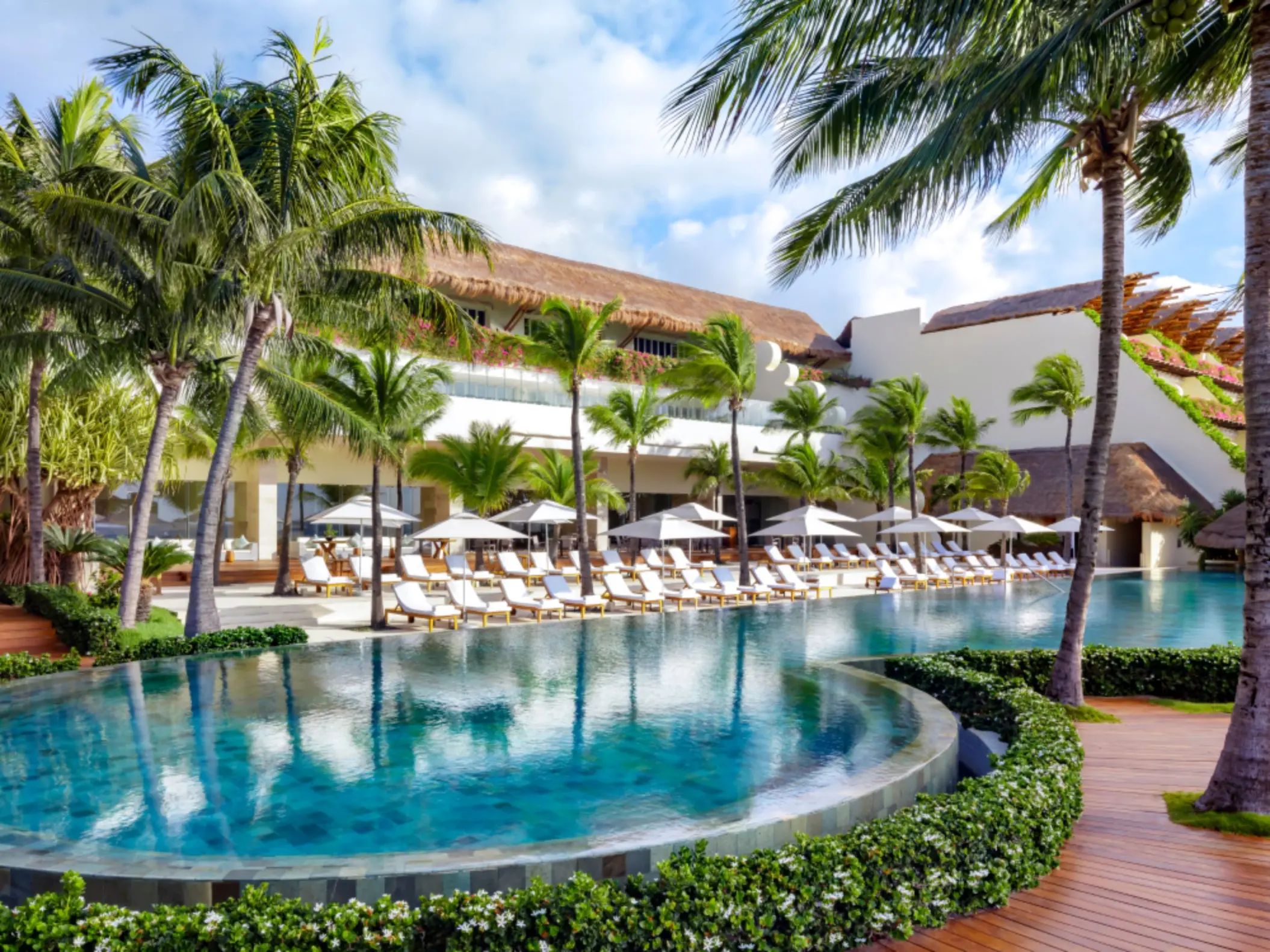 pool with poolside loungers at grand velas riviera maya resort