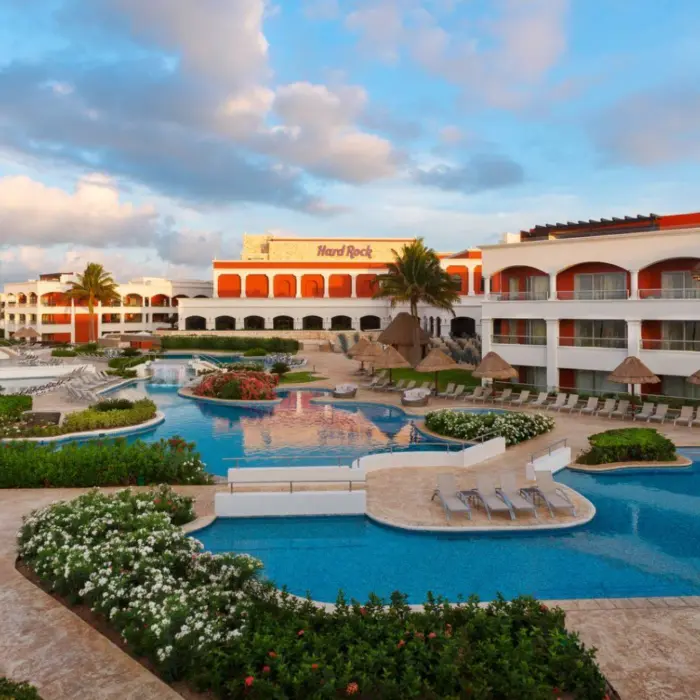 Aerial view of the Hacienda section pools at Hard Rock Hotel Riviera Maya with lush greenery and resort buildings.