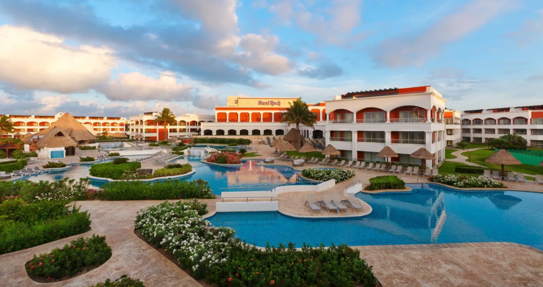 Aerial view of the Hacienda section pools at Hard Rock Hotel Riviera Maya with lush greenery and resort buildings.