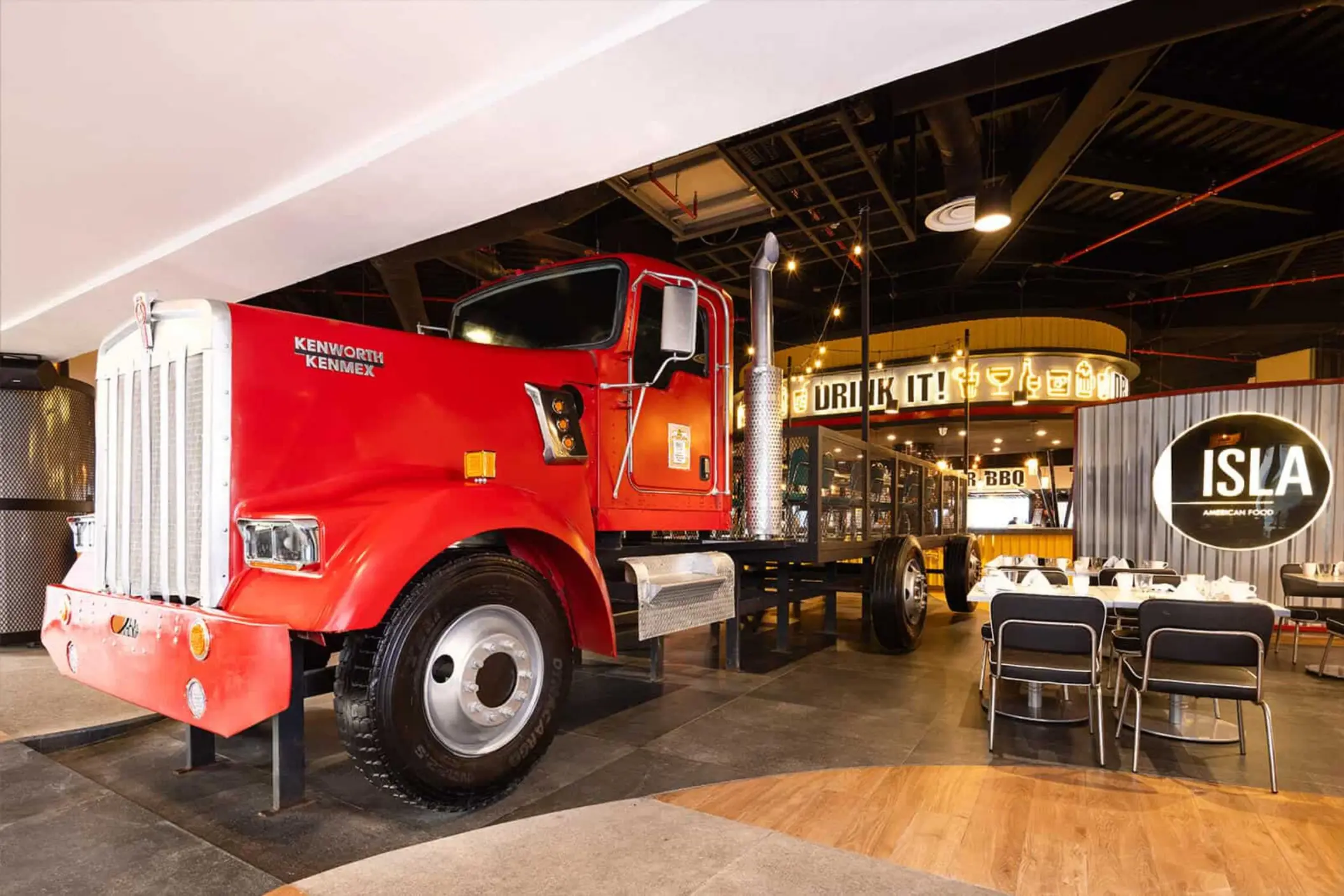 The interior of a modern restaurant featuring a full-sized red semi-truck as a centerpiece.