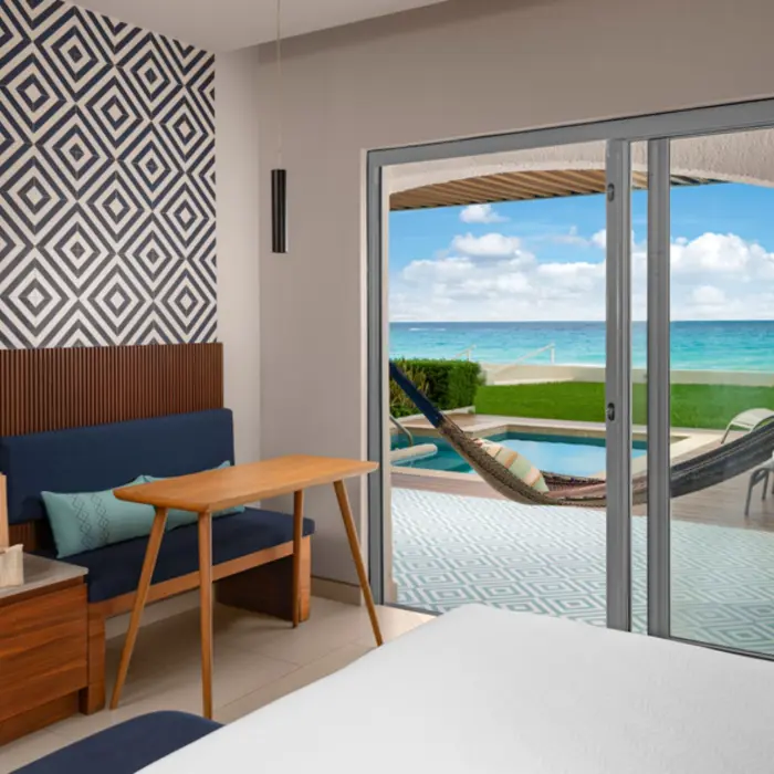 A hotel suite with a private terrace, a small plunge pool, and a hammock with a magnificent ocean view.