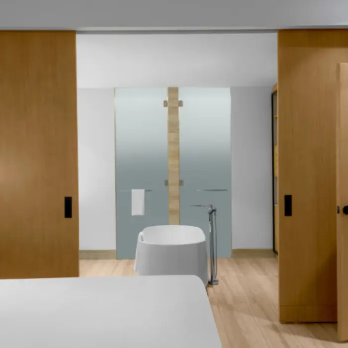 Suite interior with sliding doors revealing a freestanding bathtub and minimalist wood bathroom design.