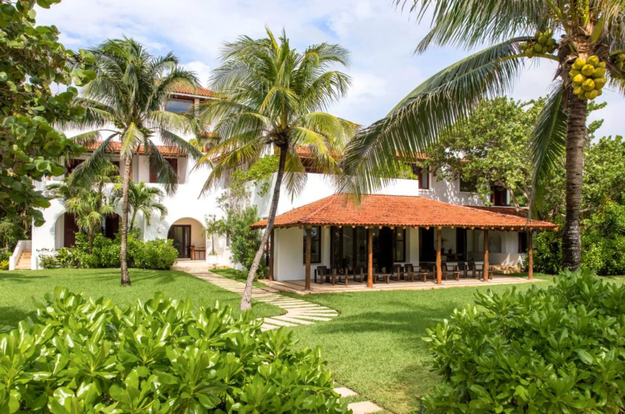 Hotel Esencia resort building surrounded by greenery