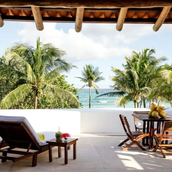 terrace with loungers and sea views of a suite at Hotel Esencia