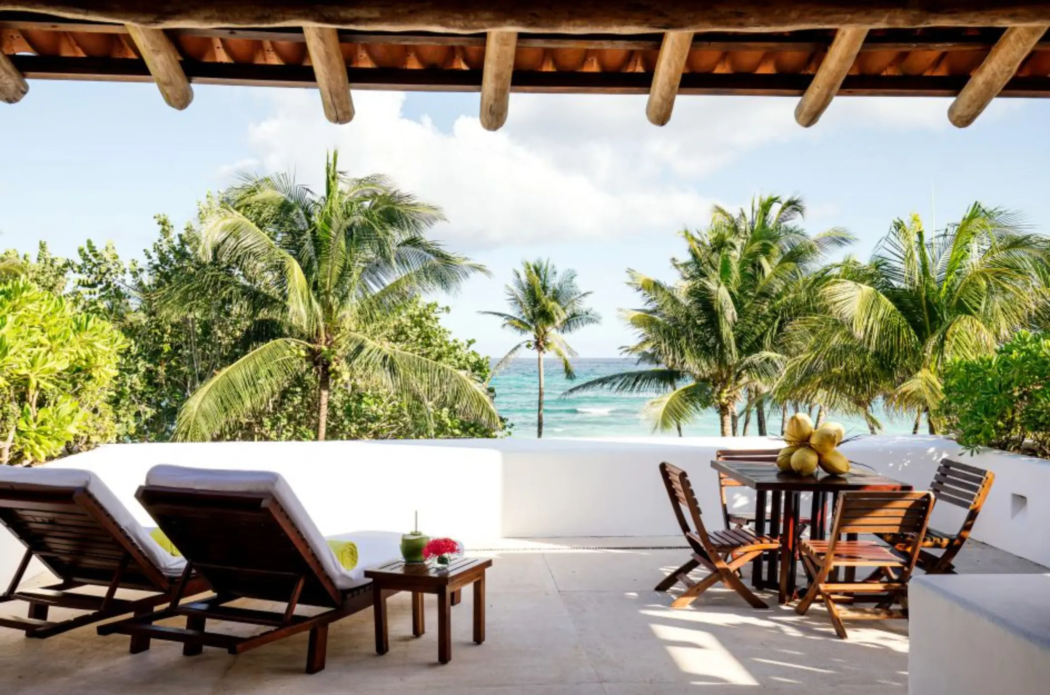terrace with loungers and sea views of a suite at Hotel Esencia