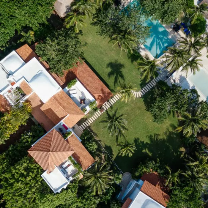top view of Hotel Esencia with its buildings and pools and landscaped gardens