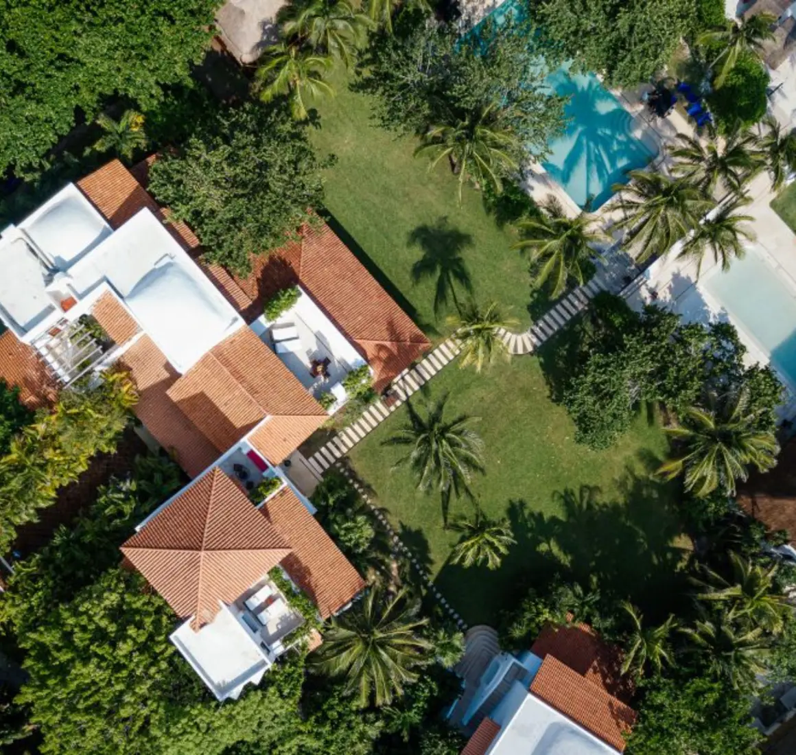 top view of Hotel Esencia with its buildings and pools and landscaped gardens