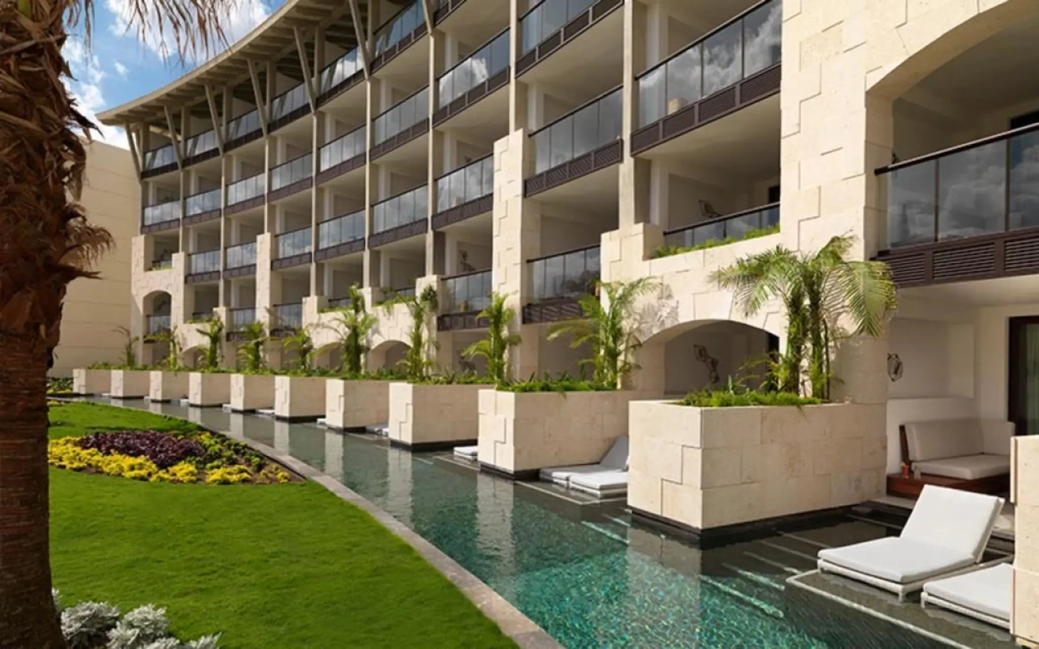 Swim-up suites with private loungers and direct access to a semi-private pool in a lush garden-facing area.