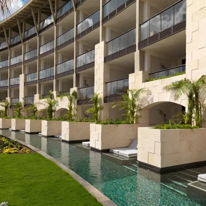 Swim-up suites with private loungers and direct access to a semi-private pool in a lush garden-facing area.