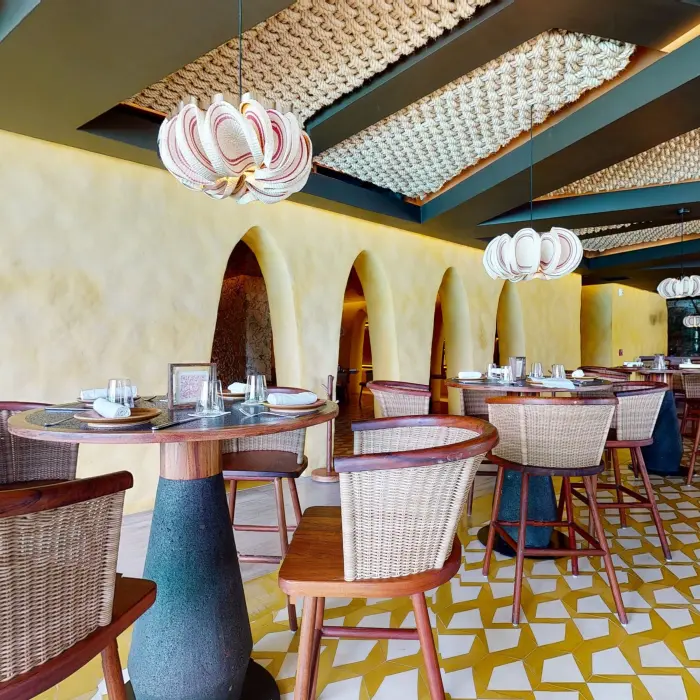 Private dining booth at Kibi kibi restaurant with bold woven accents and ambient lighting.