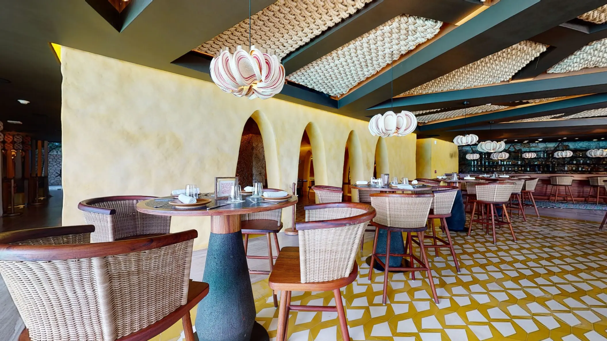 Private dining booth at Kibi kibi restaurant with bold woven accents and ambient lighting.