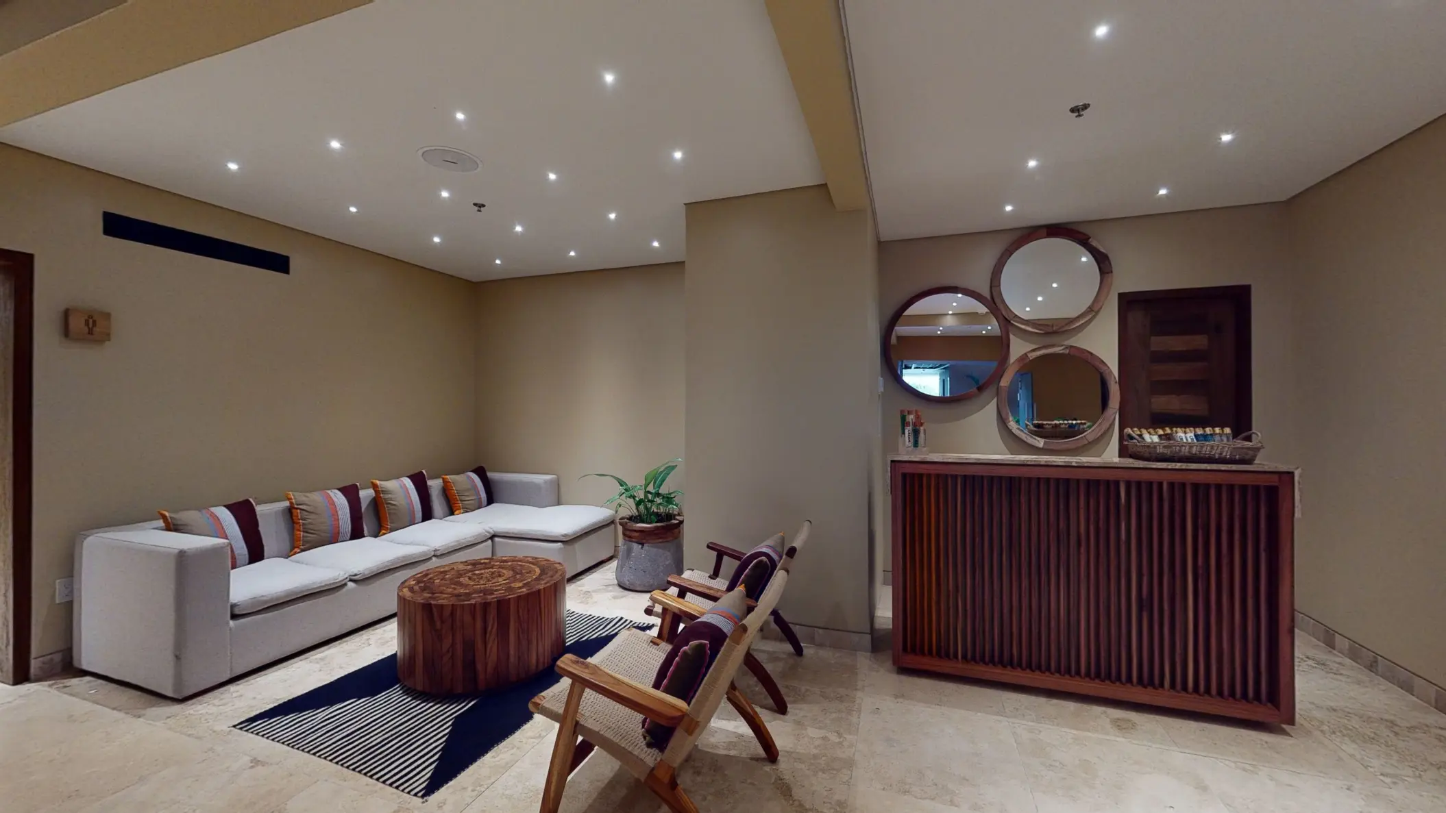 Tranquil hospitality room with cozy seating, warm lighting, and natural wood decor.