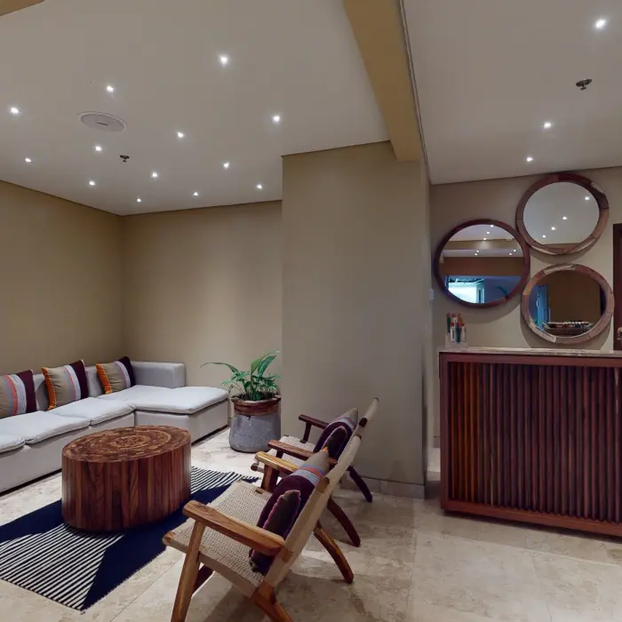 Tranquil hospitality room with cozy seating, warm lighting, and natural wood decor.