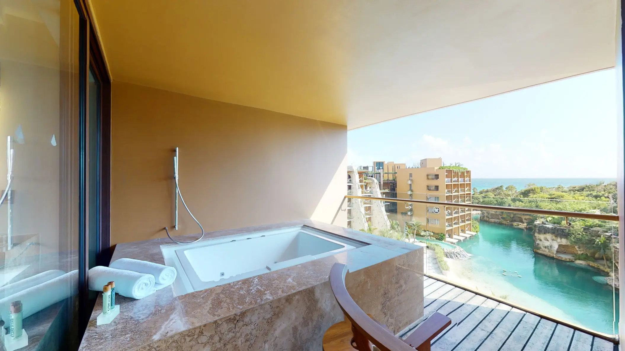 Outdoor jacuzzi on private terrace with sweeping river and ocean views.