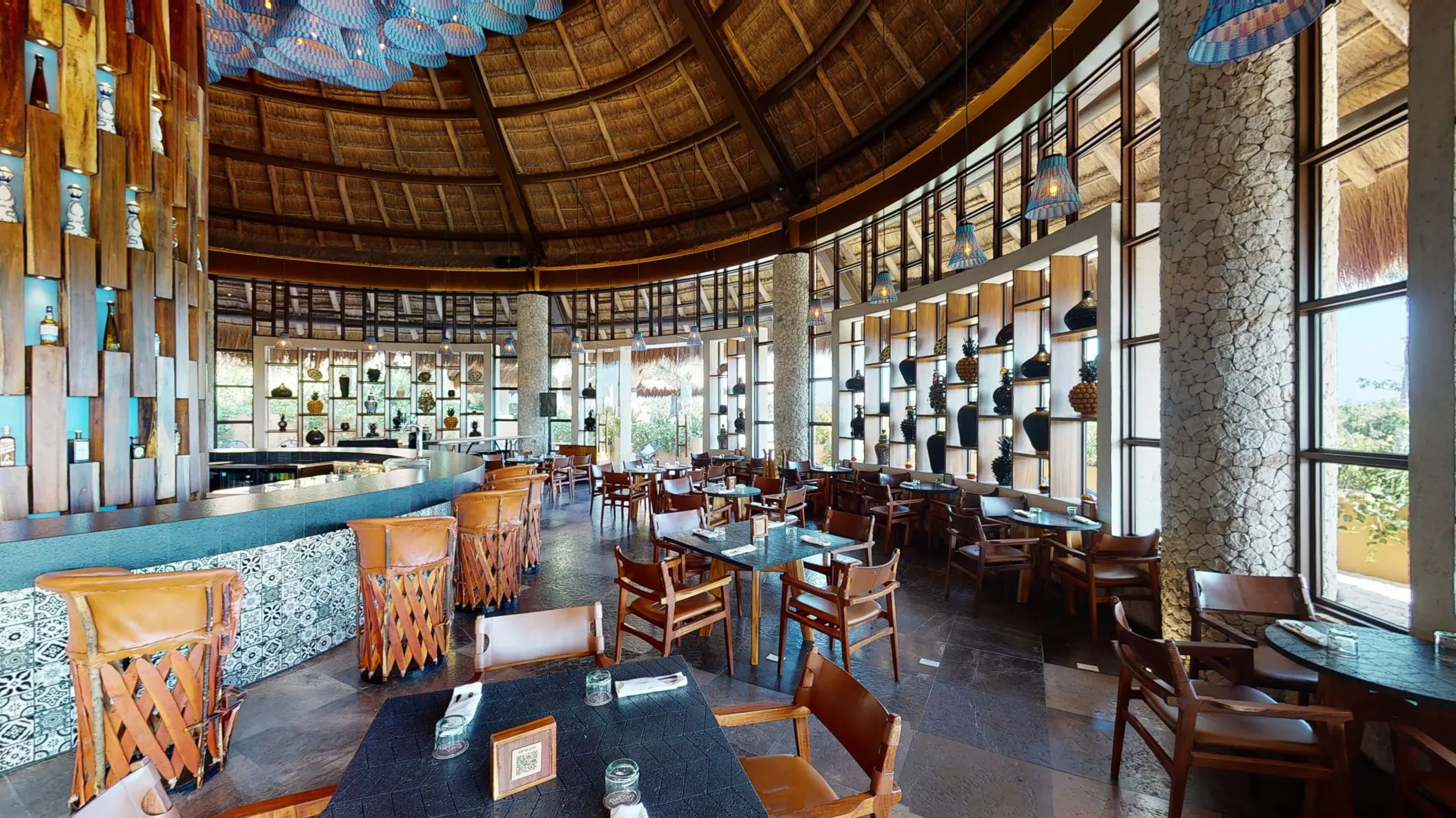 La Cantina V.I.A.I.P.Y with leather stools, hanging lights, and wall décor.