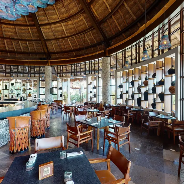 La Cantina V.I.A.I.P.Y with leather stools, hanging lights, and wall décor.