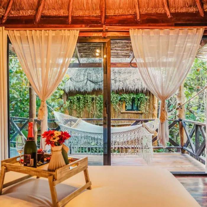 luxury room with hammock in the balcony at Hotelito Azul Tulum