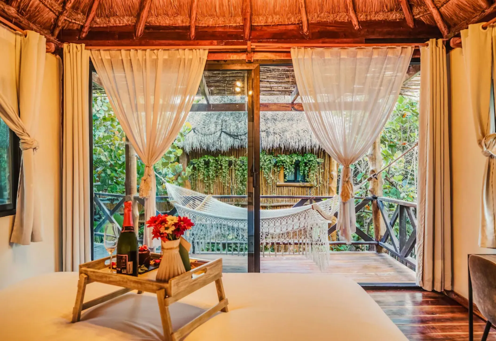 luxury room with hammock in the balcony at Hotelito Azul Tulum