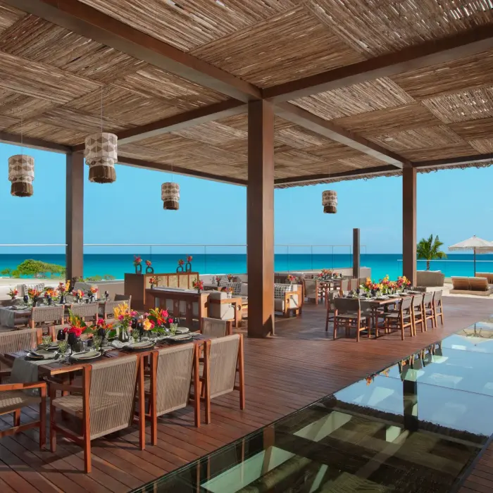 Indoor gala dinner at Ennea Restaurant with long banquet tables, chic décor, and ambient lighting.