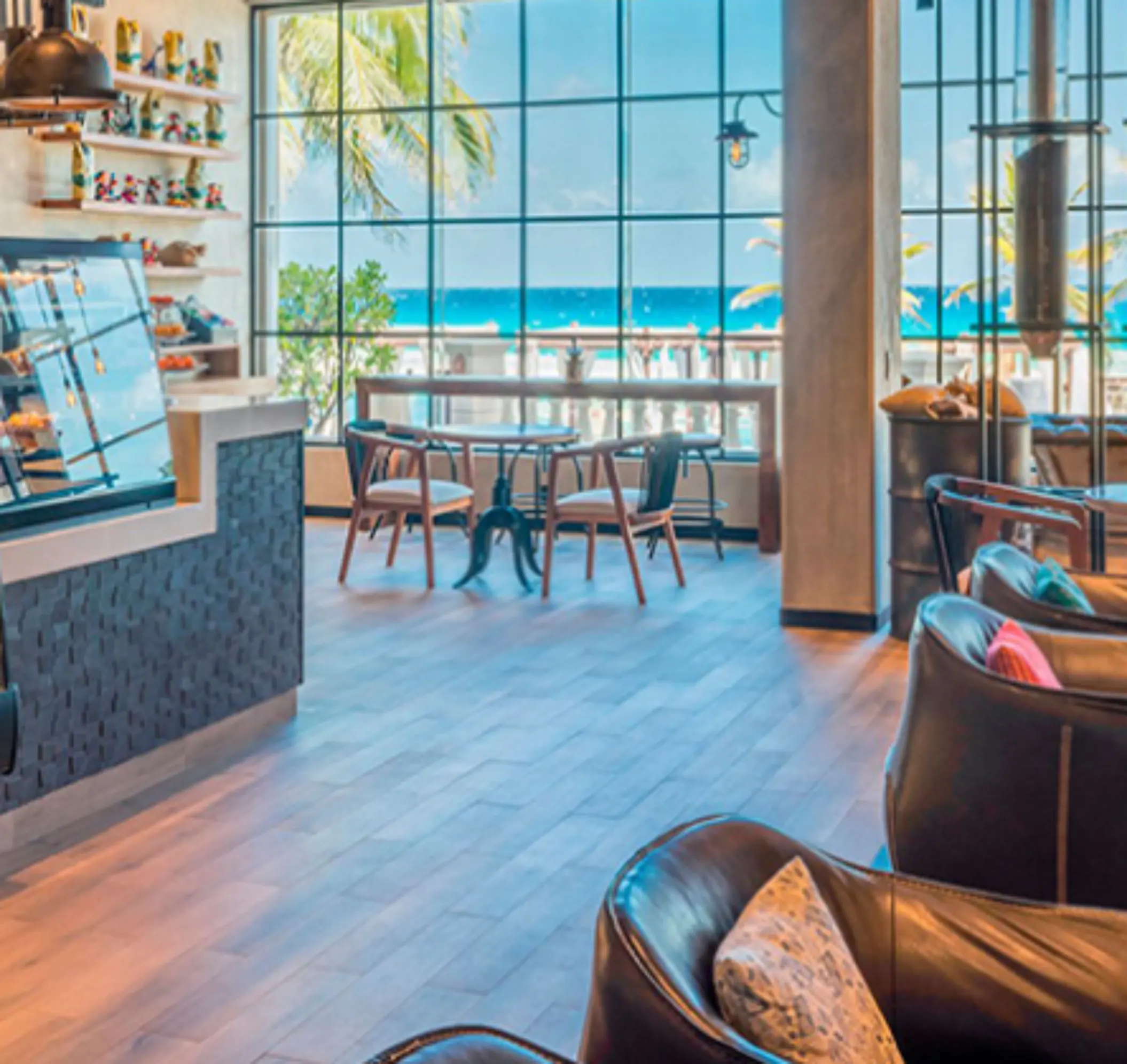 Modern coffee shop with ocean view and cozy seating, ideal for a morning espresso by the beach.