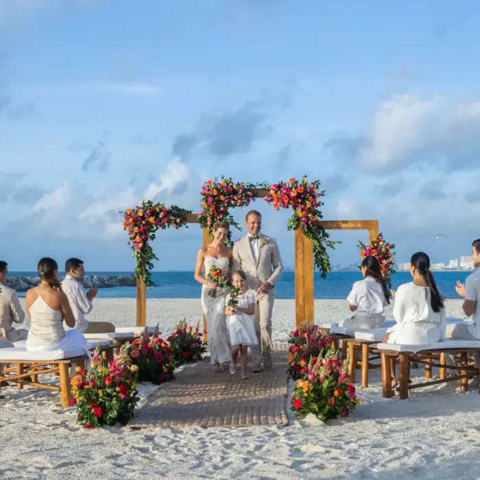 bride and groom and their child and guests at Hyatt Ziva Cancun Sahara beach venue